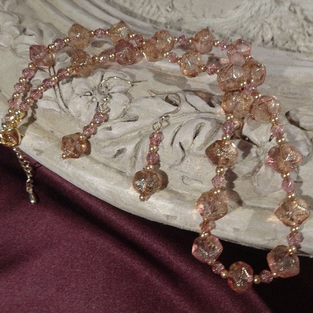 Artisanal necklace/earring set in faceted rose beads with  gold accents